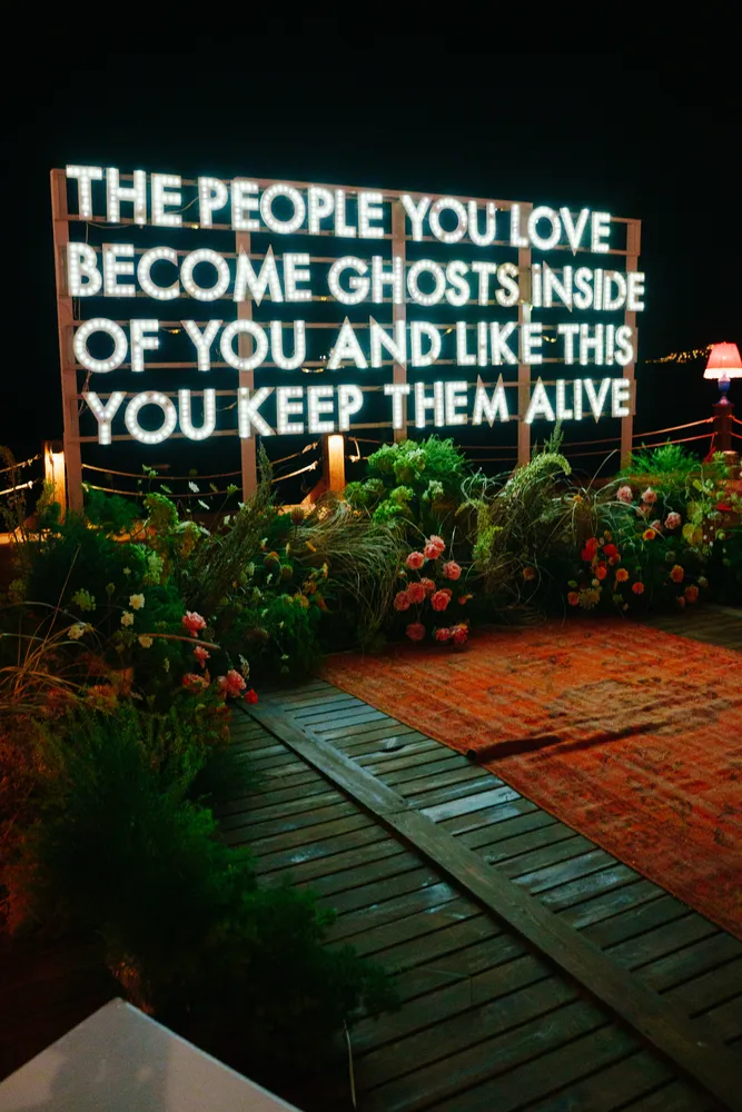 Custom neon sign and floral event design for night wedding